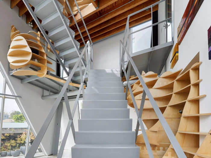 The most striking interior feature of the Tectonic House is a plywood art installation that weaves around the staircase and along the walls of the house.