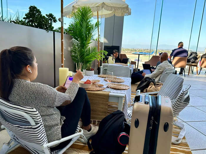 The best place to hang out in the entire Sky Club: The low-slung tables surrounded by even lower-slung beach chairs on the outdoor patio.