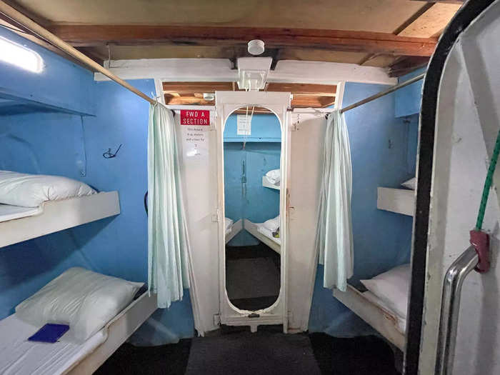 Past the two bathrooms, and toward the bow of the boat, were two more rooms with four beds each.