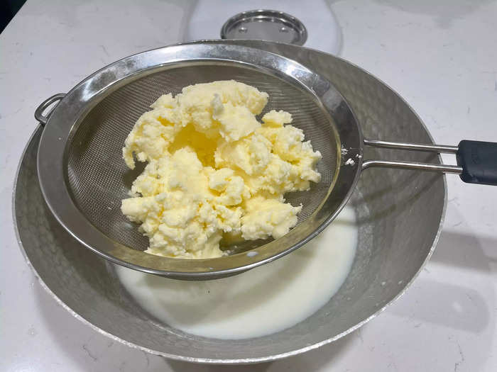 Use a strainer to separate the solid butter from the buttermilk.