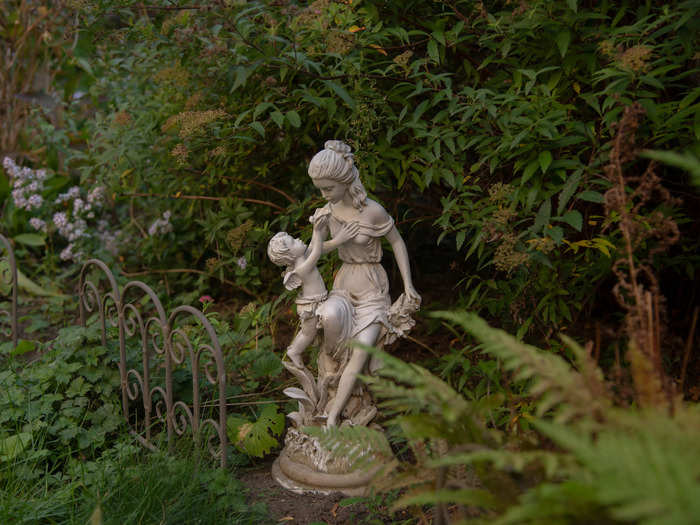 There were multiple stone statues hidden among foliage that made the backyard feel like it could be haunted.