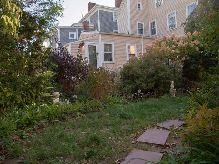 A stone path led to the small backyard that had been beautifully curated by the gardener Marchand hired.