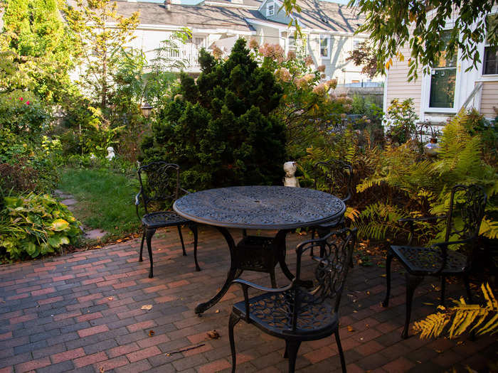 An outdoor table and chairs were set up on the patio for guests.