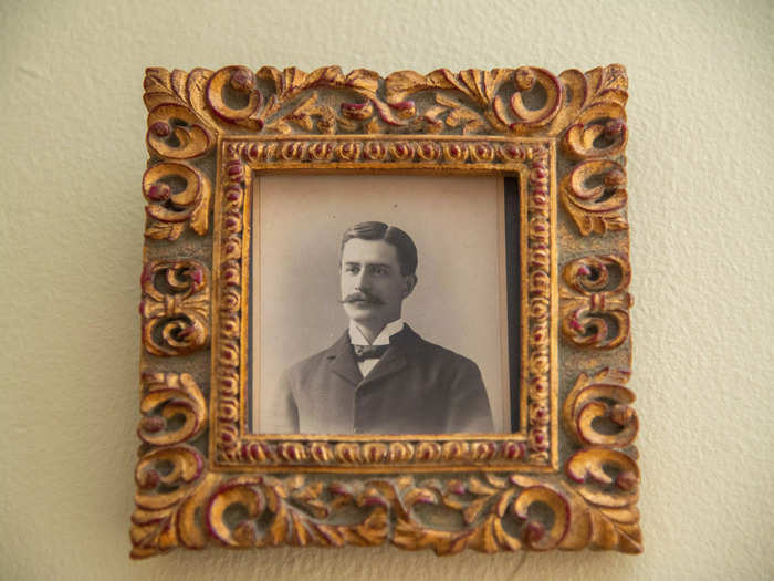 Framed black-and-white photos hung on the wall around the fireplace.