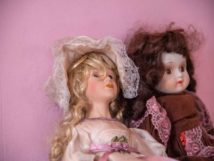 The two dolls sitting on a side table helped give the house a spooky feeling.