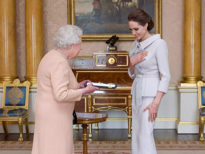 Angelina Jolie was visibly moved when she received the insignia of an Honorary Dame from the Queen for her humanitarian work combating sexual violence in 2014.