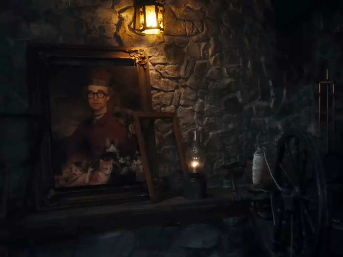 Swift glances at a portrait of Jack Antonoff as the prince, surrounded by cats.