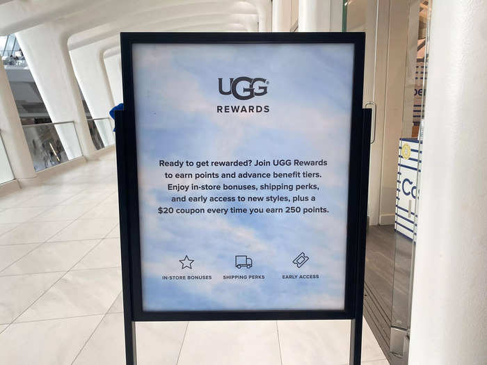 A sign encouraging customers to join the Ugg rewards program to receive shipping perks, store bonuses, and a $20 coupon was set up by the entrance.