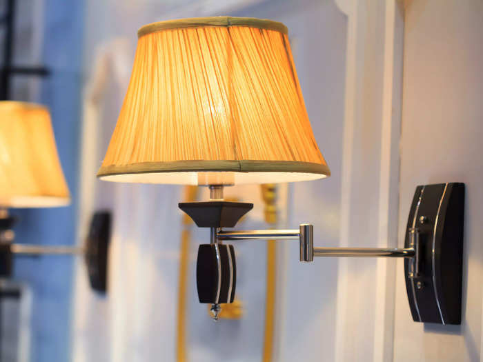 Swap out your table lamp for a wall sconce to reduce clutter.