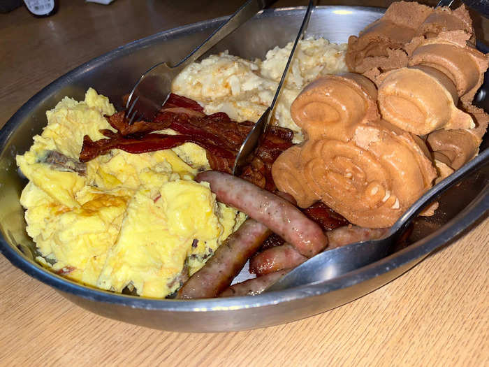 The main breakfast skillet consisted of pecan-smoked brisket and eggs, Mickey-shaped waffles, bacon, sausage, cheesy potato casserole, and syrup.