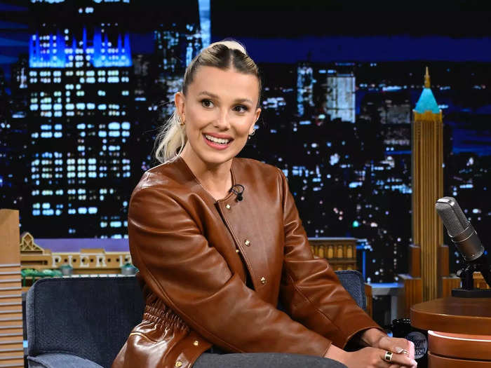 To kick off her "Enola Holmes 2" press tour, Millie Bobby Brown wore an office-chic look for an appearance on "The Tonight Show Starring Jimmy Fallon."