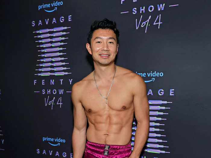 Simu Liu turned heads by wearing silky magenta Savage X Fenty pants and tying the coordinating top around his waist, leaving his chest exposed.
