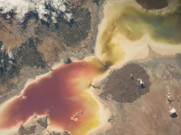 Astronauts can also see long-term damage humans have caused. This lake is overrun with red algae because dams and agriculture have drawn so much water from it, and drought has further depleted it.