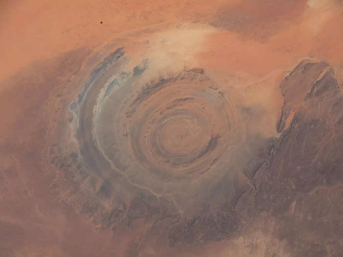 Prominent natural features, like this circular rocky uplift in the Sahara desert, often catch astronauts