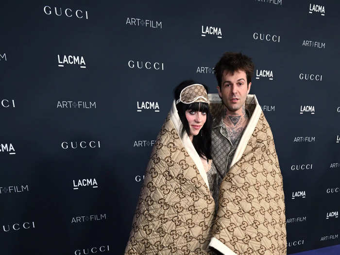 Billie Eilish and her new boyfriend Jesse Rutherford made their red carpet debut cuddled up beneath a Gucci blanket.