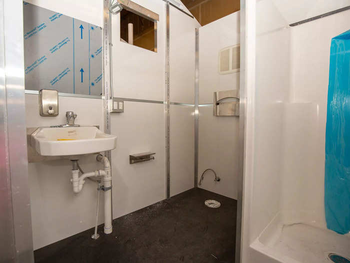… and a bathroom with a shower, toilet, and sink.