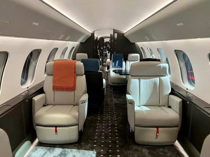 This makes the aircraft the largest of any business jet on the market. The four spaces include a meeting space, which has two sets of seats facing each other...