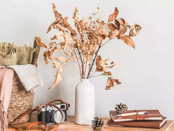 Ceramic vases filled with branches bring a sculptural element to any space.