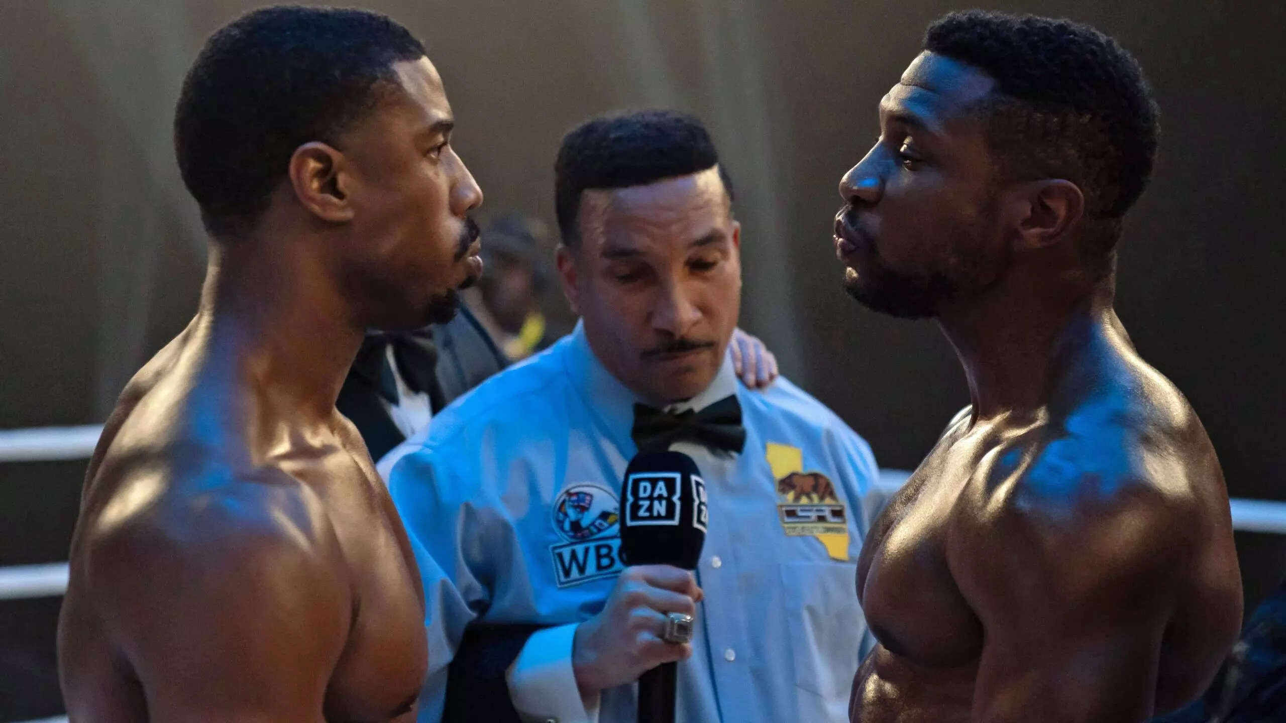Michael B. Jordan and Jonathan Majors looking at each other inside a boxing ring