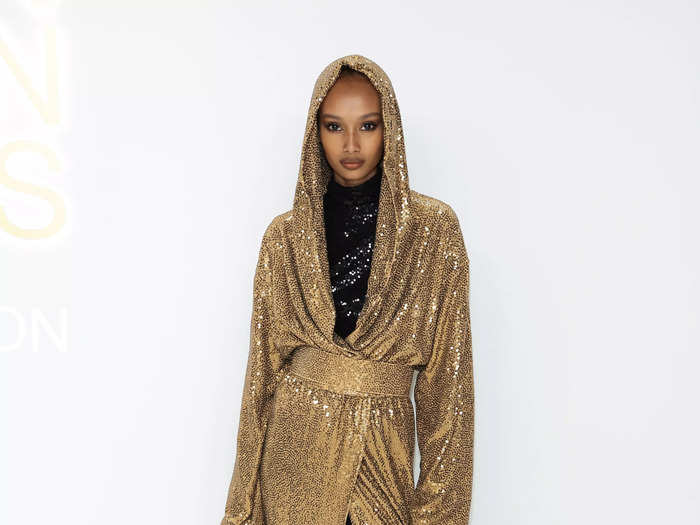 Model Ugbad Abdi dazzled in a sequinned Michael Kors gown with a matching clutch and heels.