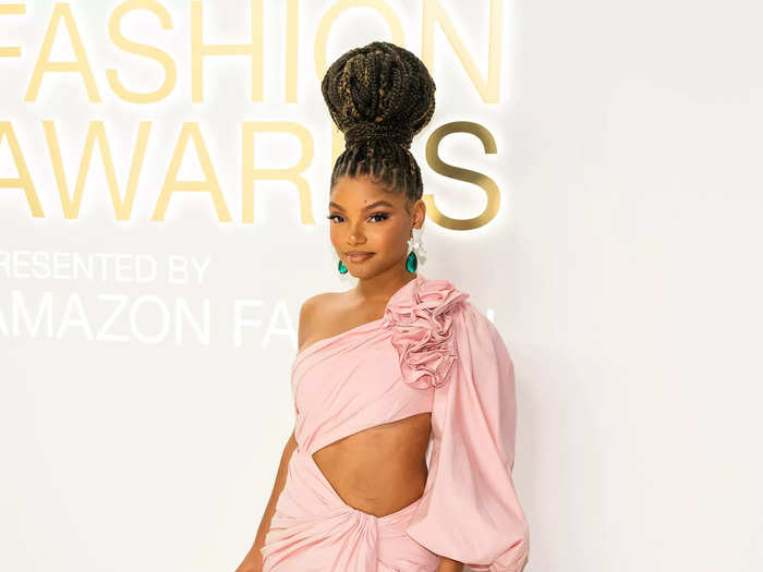 "The Little Mermaid" star Halle Bailey walked the carpet in a blush-pink Carolina Herrera gown with dramatic ruffles and a thigh-high slit.