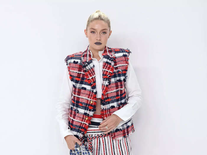 Gigi Hadid donned a mismatched red, white, and navy print ensemble by Thom Browne with charcoal lipstick and slicked back hair.