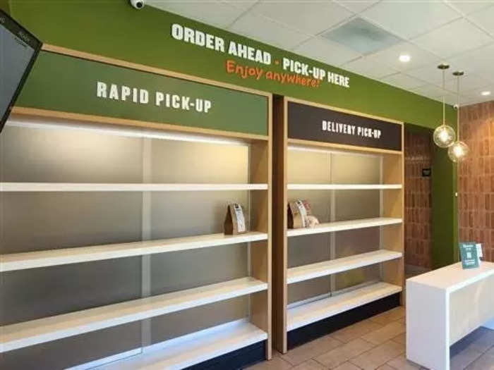 Customers pick up their orders on shelves that take up an entire wall of the store, using the Panera Rapid Pickup design the chain has been using since 2016.