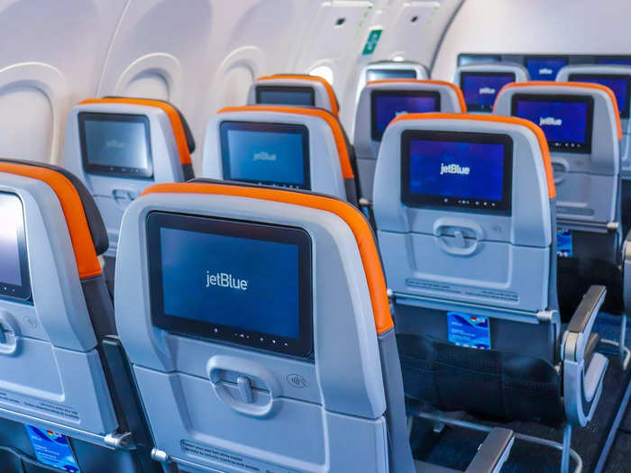 JetBlue seats are more padded, and the aircraft has inflight TV screens, complimentary WiFi, snacks, and drinks, and much more legroom in regular economy — at least four inches more than Spirit.