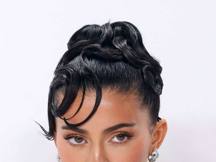 Kylie Jenner exuded sultry glamour with a swirling updo.