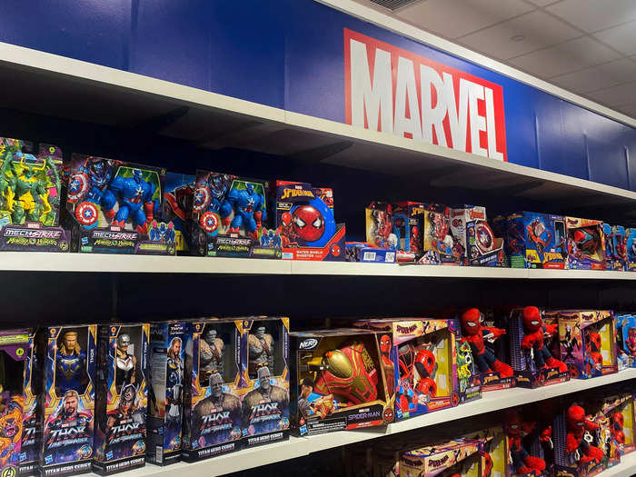 In the middle of the store was a wall stacked high with Marvel superhero figurines that towered above me.