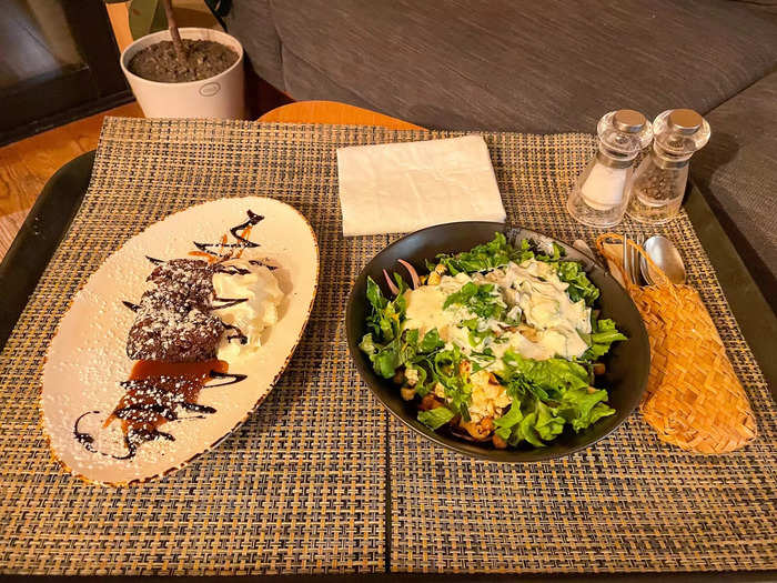 Shortly after, Toni arrived with dinner. It was a mammoth salad with greens from her garden, crispy chickpeas, cauliflower, shallots, and dressing. For dessert, I had rich sticky date pudding.