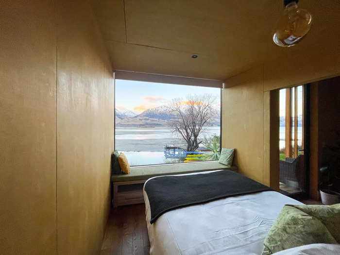 On the other side of the divider was an enormous, cozy bed with nearly floor-to-ceiling views out onto Lake Wakatipu.