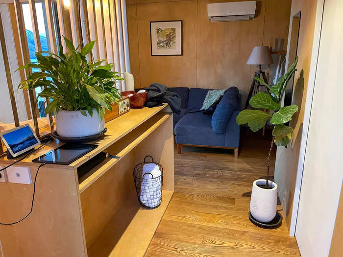 A shelving unit and wooden division created a partition between the entryway and the sleeping area.