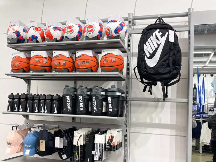 By the registers, a shelf was stacked high with sports accessories like Nike basketballs and water bottles.