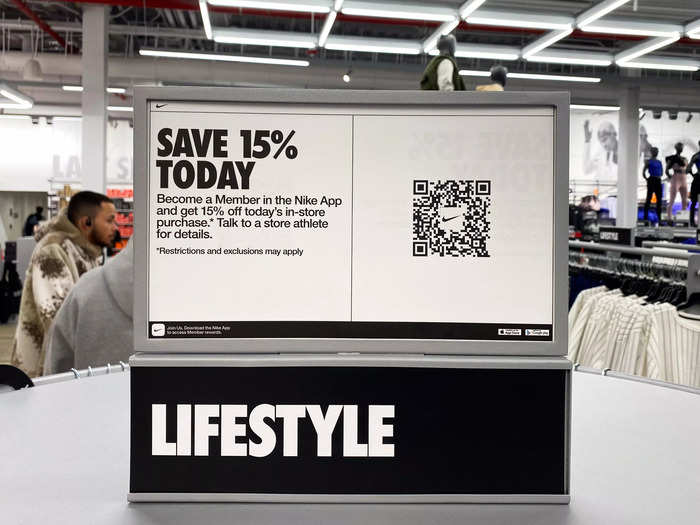 A sign with a scannable QR code encouraged shoppers to become Nike members through the app to receive 15 percent off an in-store purchase.