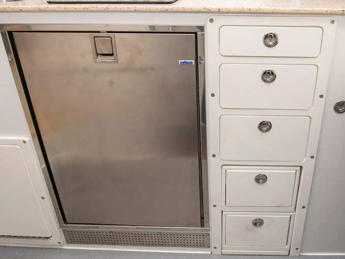 There were several drawers in the kitchen unit to store cookware, utensils, and dry goods.