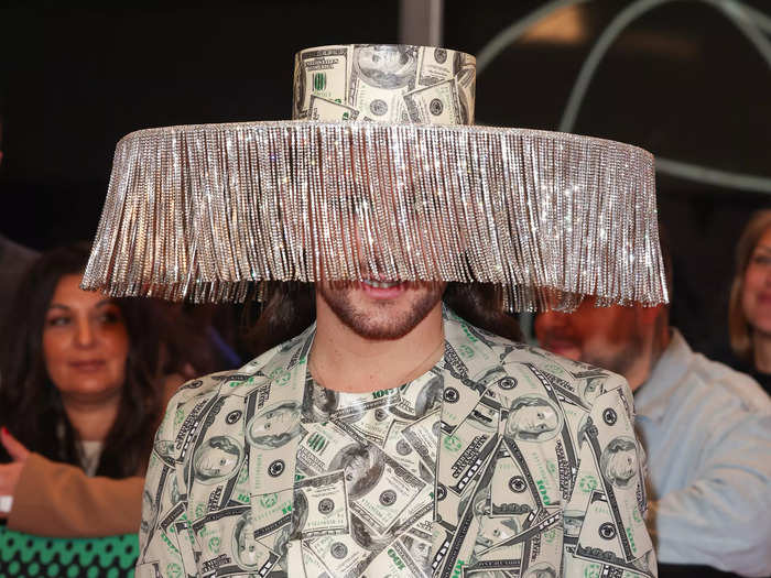 German television personality Riccardo Simonetti wore one of the most interesting looks of the night: a suit and hat made of US dollar bills.