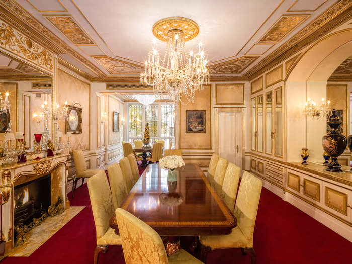 The primary dining room includes a 10-person table, several pieces of art, and yet another crystal chandelier.