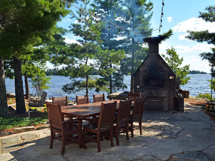 The backyard features a patio that comes with a large wood-fired oven.