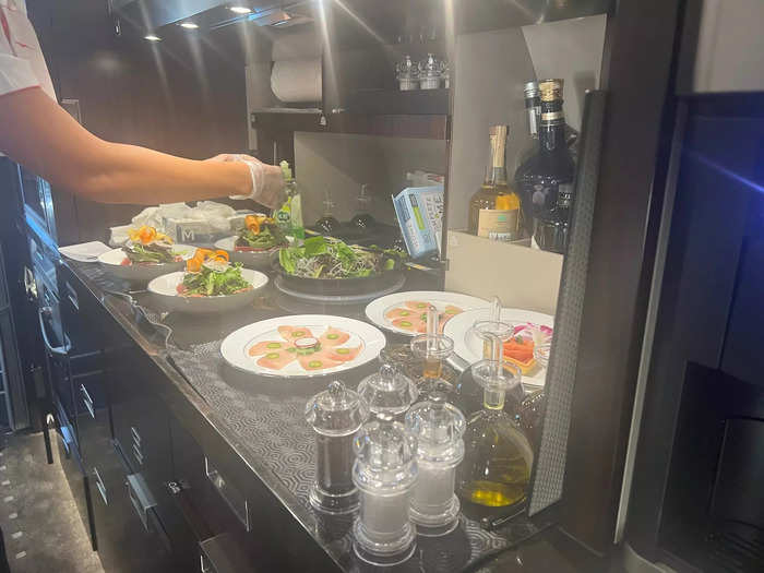 Then, cabin hostesses will prepare the food in the galley area of the jet, which has glassware, convection ovens, and other equipment available.