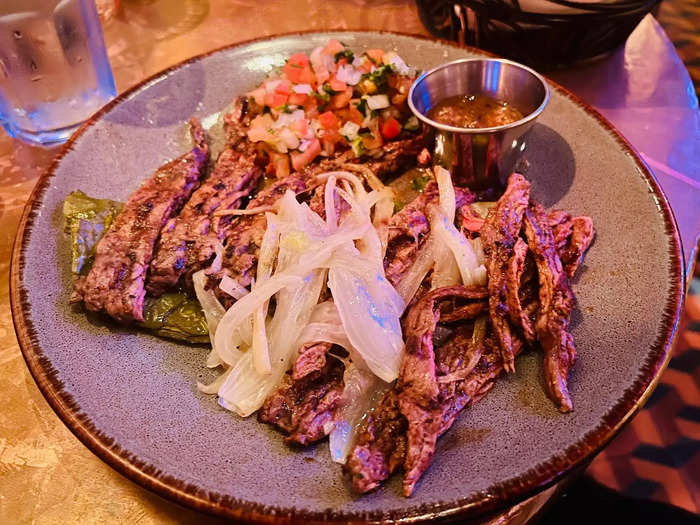 While I enjoyed the vegan enchiladas, the main meat dishes I tried were the real stars of the show, particularly the $29.95 tacos al carbon — wagyu steak served with tortillas, a nopal paddle, grilled onions, and salsa albanil.