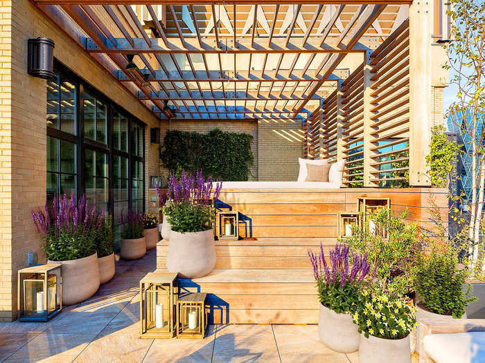 Leading through double French doors is a 1,000-square-foot landscaped terrace with a teak pergola for shade.