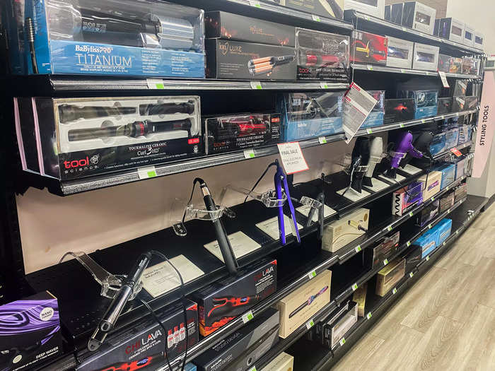 An aisle in the middle of the store was stocked full of hair dryers, straighteners, and curlers.