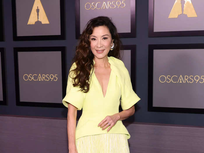 Michelle Yeoh stunned in a neon yellow gown with many interesting details.