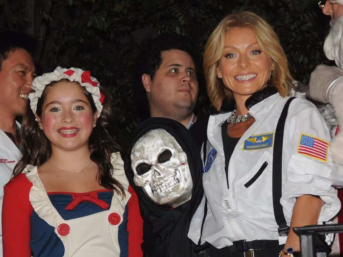 The following year, Ripa took Lola and her youngest son Joaquin to the 40th Annual Village Halloween parade in New York. The three of them were photographed in their costumes supporting Save Lives New York in October 2013.