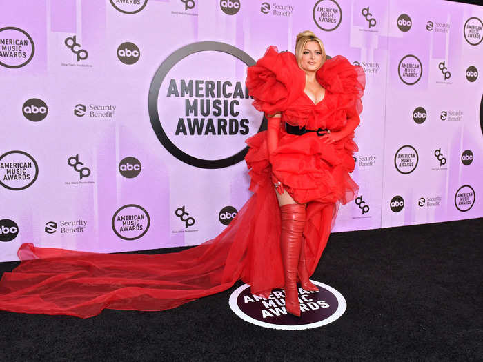 Bebe Rexha wore a striking tulle gown with dramatic shoulder ruffles, a flowing train, and matching red boots.