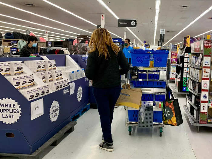 Customers searched through piles of discounted games and DVDs while workers restocked.