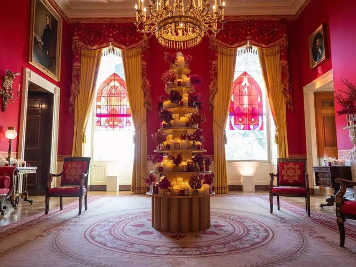 In the Red Room, stained glass windows shine alongside a tower of candles.