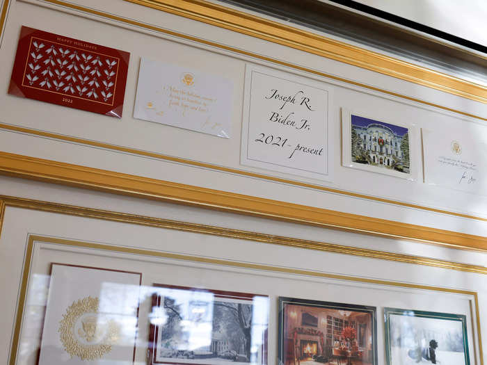 Biden family Christmas cards are displayed in the Booksellers Hallway.