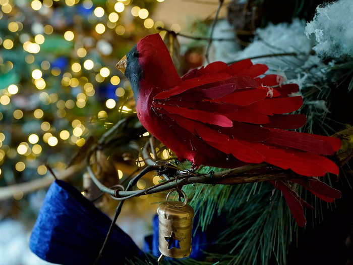 The beams and columns of the East Wing lobby are lined with greenery and red cardinals, which are thought to signify the presence of lost loved ones.